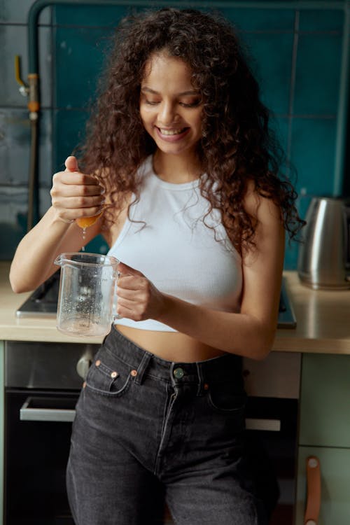 Woman in White Tank Top Holding Clear Glass Jar