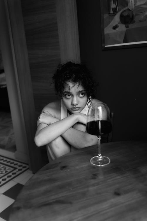Grayscale Photo of Woman Holding Wine Glass