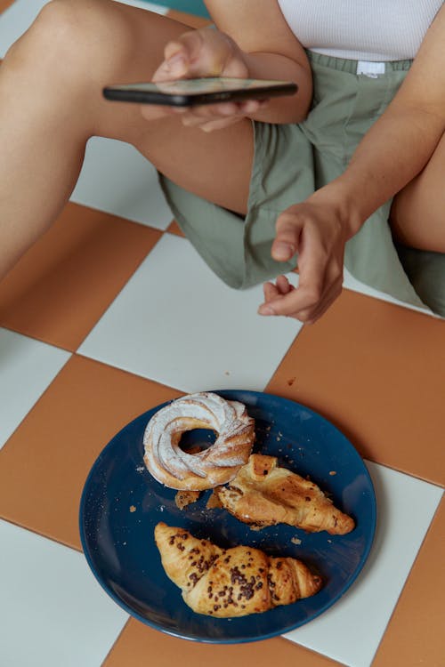 Person Holding Blue Round Plate With Doughnut