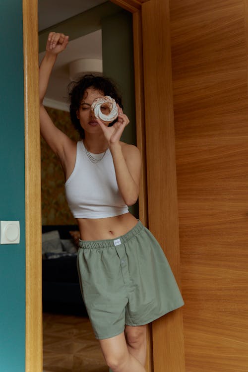 Woman Wearing a Tank Top Holding a Bread