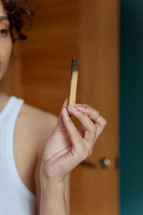 Woman Holding Incense in Hand