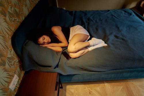 Free Pretty Woman Lying on a Bed Stock Photo