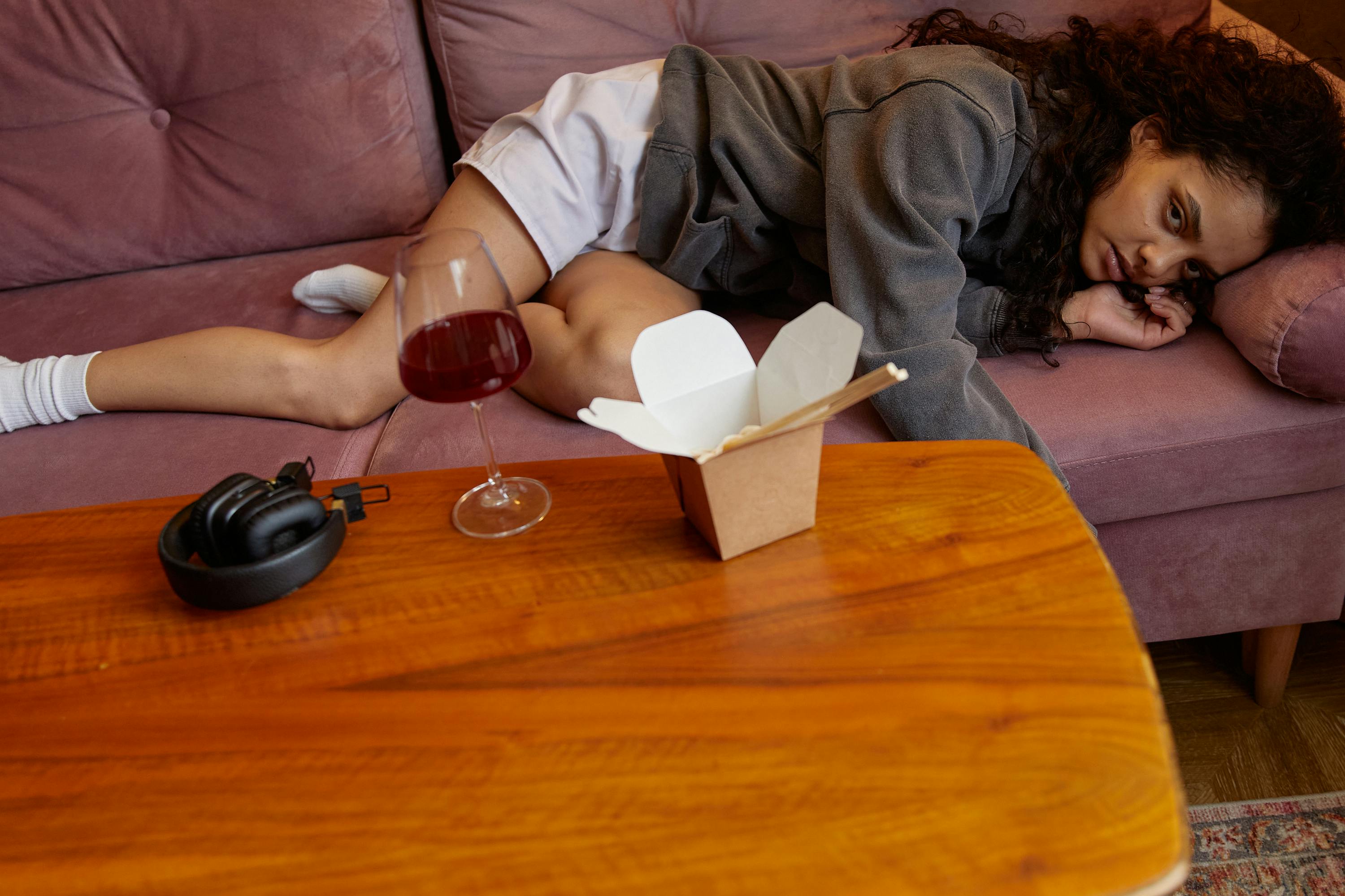 Woman in Gray Sweater Sitting on Brown Couch