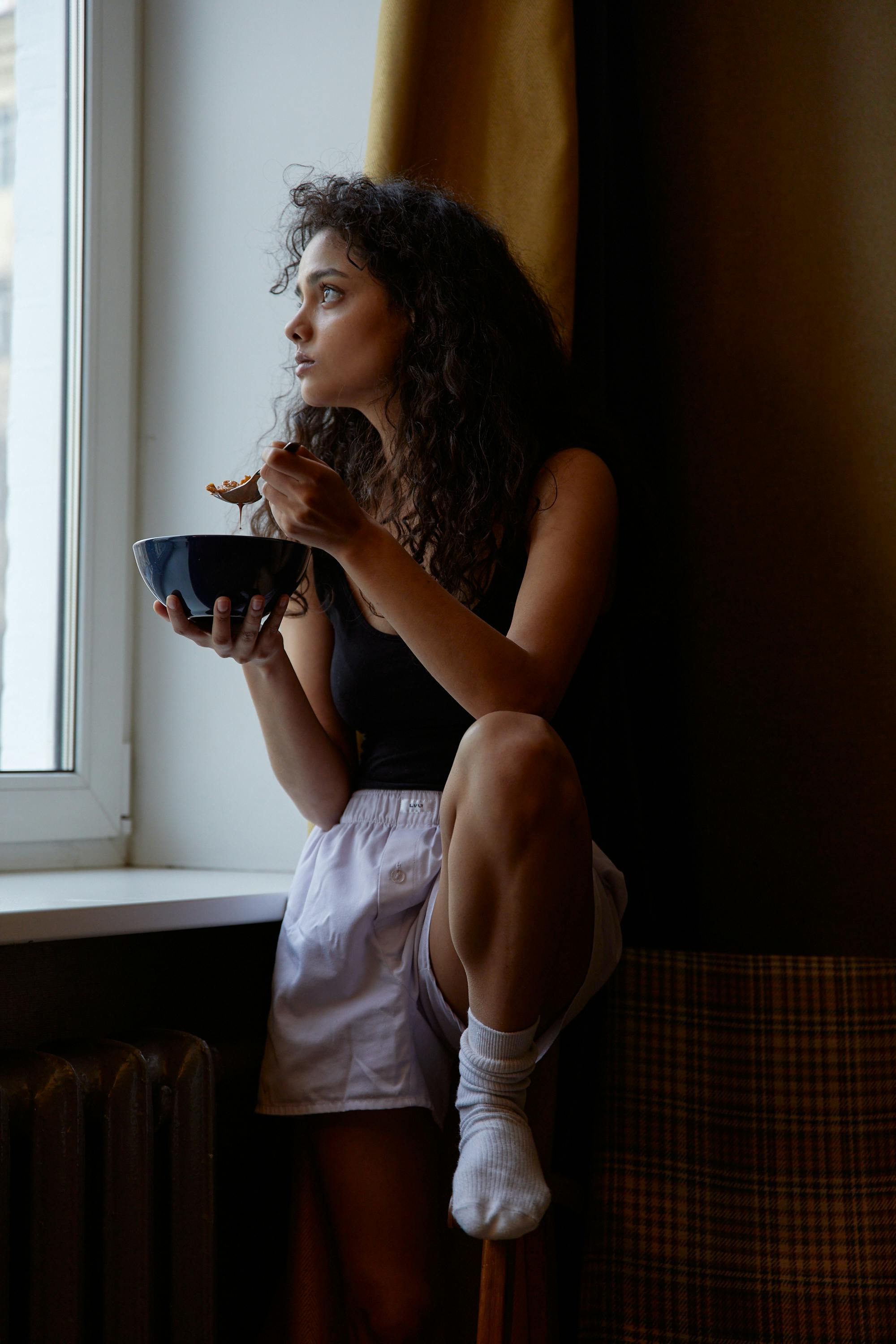 Woman in White Tank Top Holding Blue Ceramic Bowl