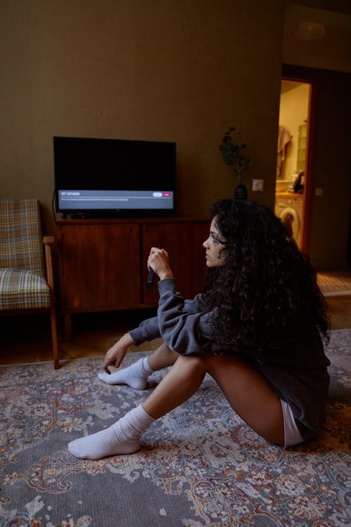 Woman in Black Long Sleeve Shirt Sitting on Floor