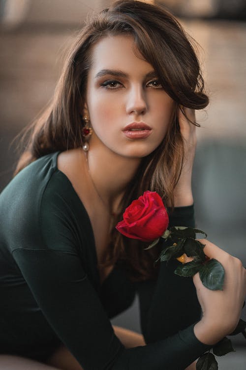 Free Elegant woman with red rose touching hair Stock Photo