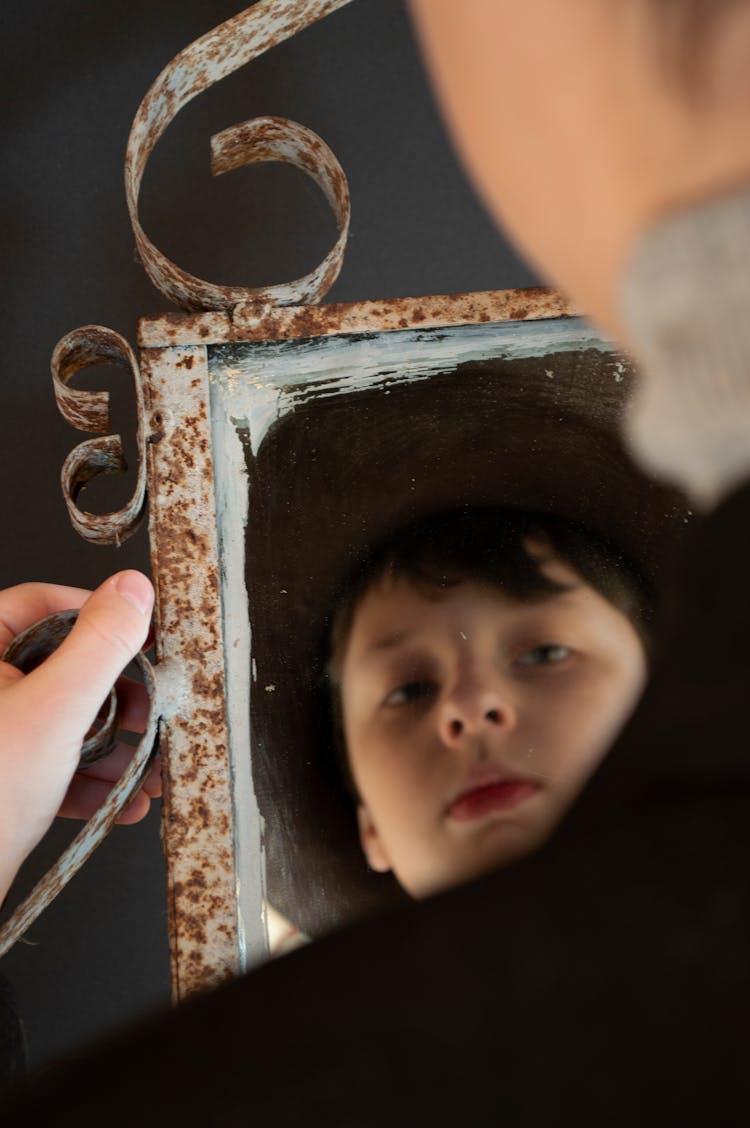 Reflection Of Little Boy Looking At Mirror