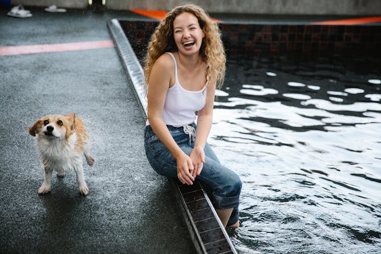 Happy Woman With Welsh Corgi Pembroke On Poolside