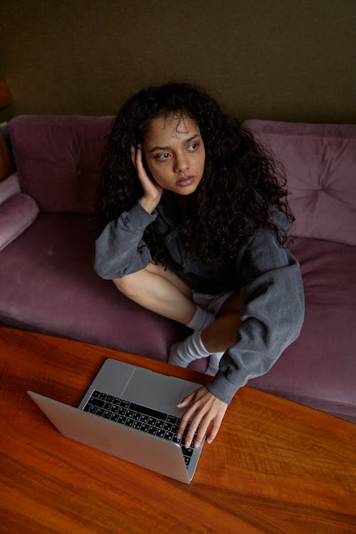 Woman in Black Shirt Using Macbook Air