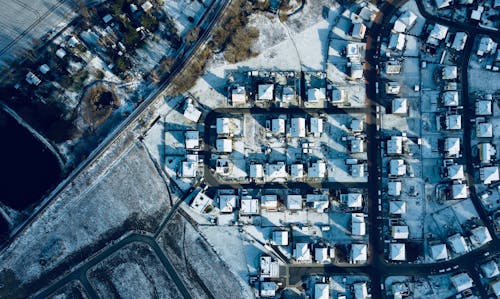 Drone Shot of Houses Covered in Snow 