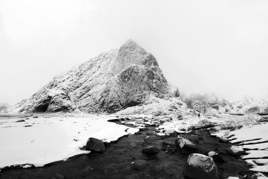 Winter View of River Flowing Towards Snow Capped Summit