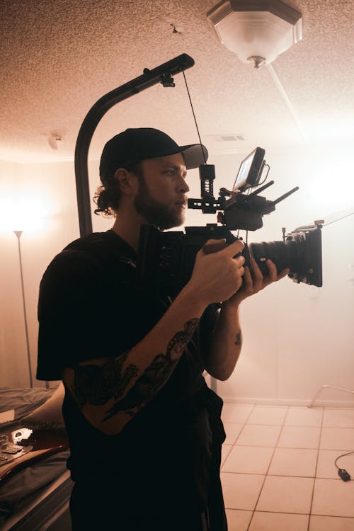 Man in Black Shirt Holding a Camera Build