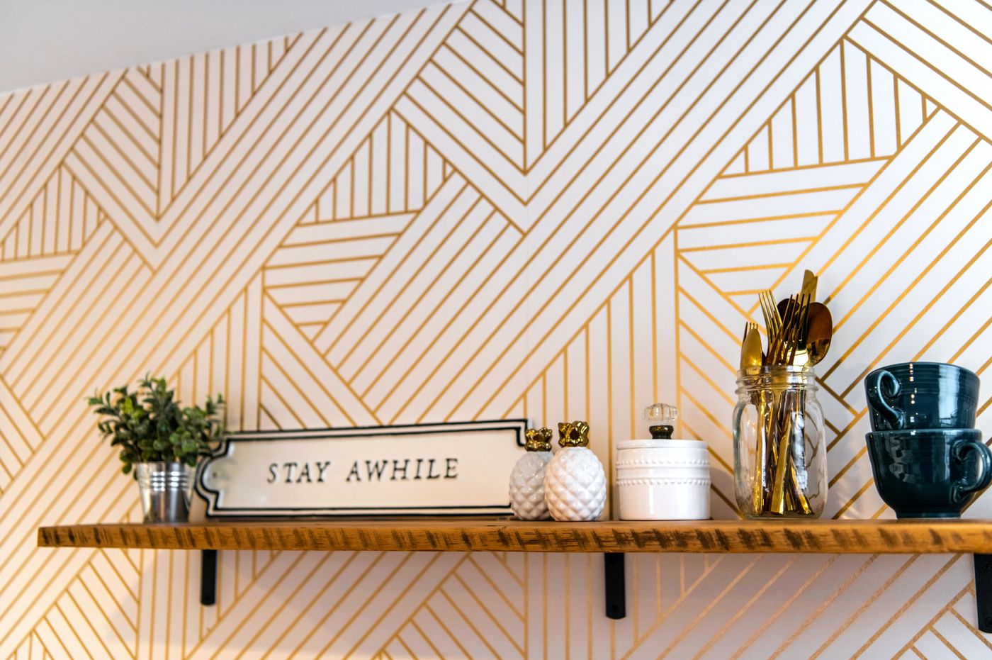 Decorative geometric wall treatment with shelf and coordinated interior details