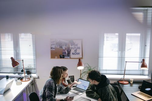 Two colleagues reviewing listing analytics on a laptop — photo by Ivan S on Pexels