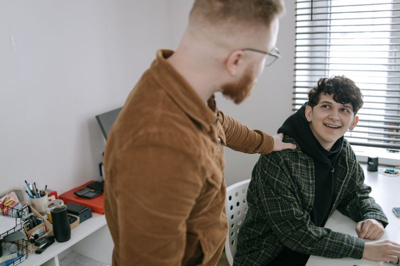 Two colleagues having a supportive conversation in the workplace