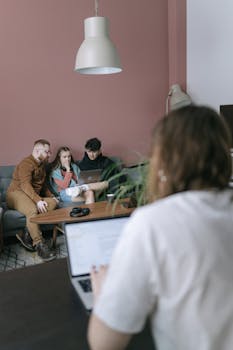 A diverse group of young adults collaborating in a modern office.