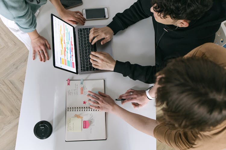 High-Angle Shot Of Three People Working In The Office