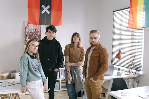 A group of young adults with diverse backgrounds gathered in a stylish office for collaboration.