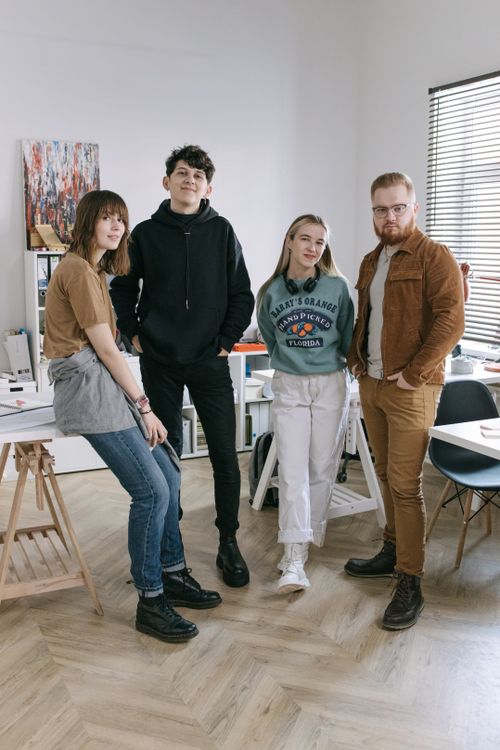 Free A group of diverse young adults posing together in a modern office environment. Stock Photo