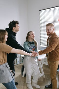 Group of young adults working as a team in a modern office setting.