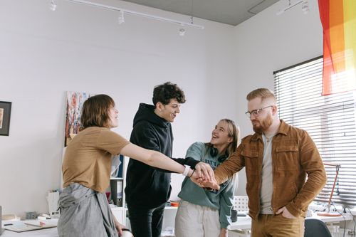Free A group of colleagues engaging in team building with hands joined, expressing unity and camaraderie. Stock Photo