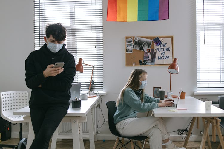 Man And Woman Wearing Facemask In Office