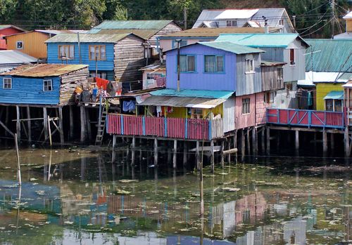 Free Vibrant stilt houses on the water in Castro, Chile, showcasing unique wooden architecture. Stock Photo