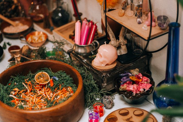 Herbs, candles and botanical tools for Hoodoo folk magic ritual