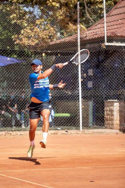 Man Midair After Hitting a Ball in Tennis 