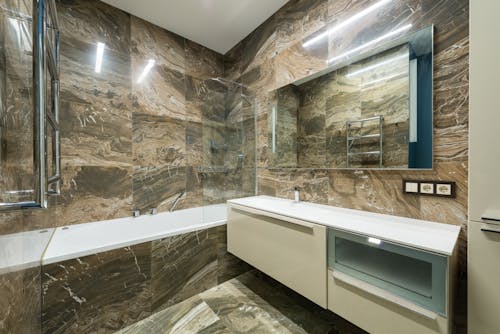 Interior of modern bathroom with marble walls