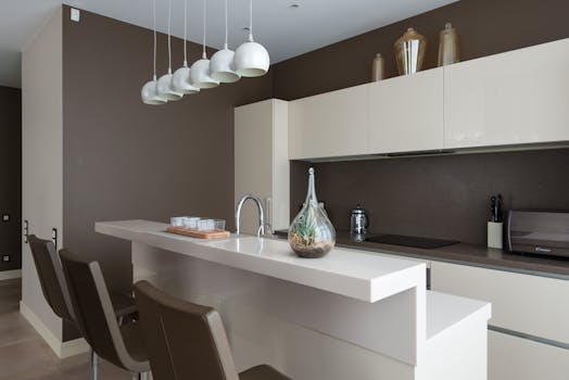 Stylish interior of contemporary spacious kitchen zone with light furniture in contemporary flat