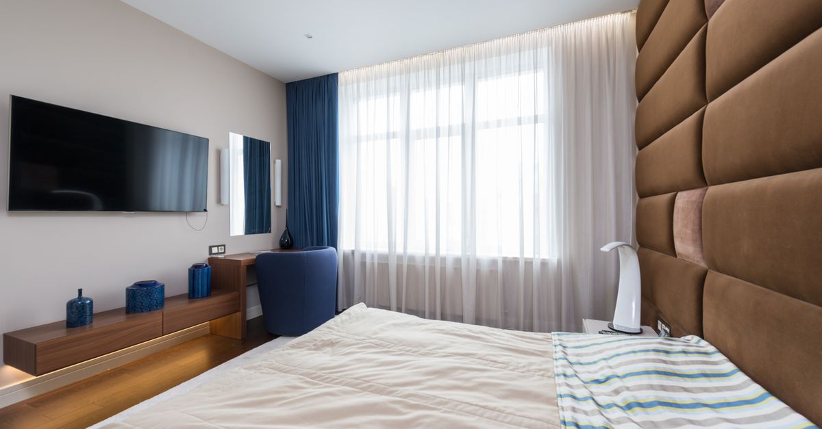 Minimalist bedroom with smart curtains, no visible screens, soft ambient light