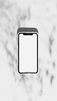 Modern smartphone with blank white screen on minimal background, perfect for tech concepts.