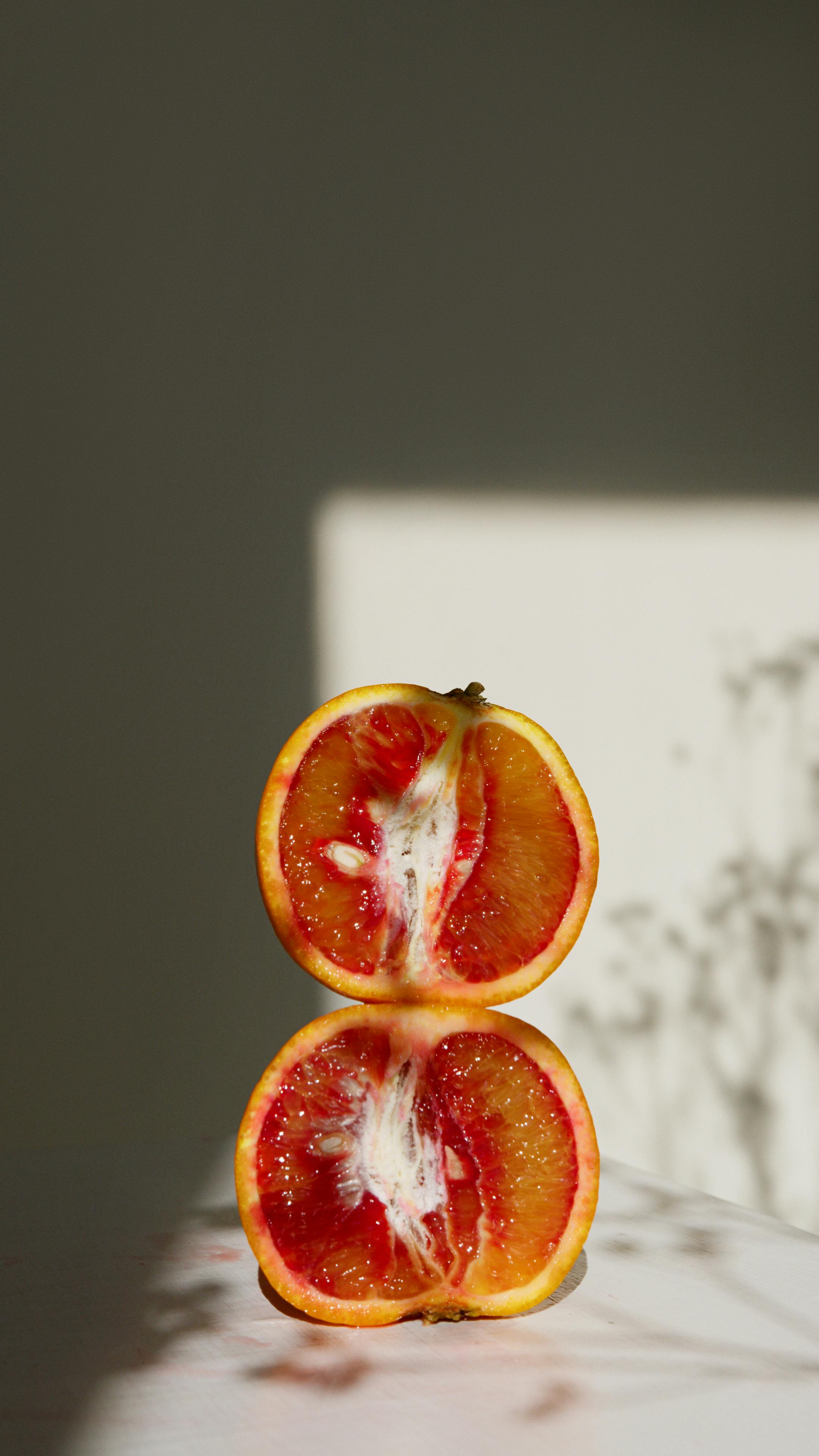 sliced blood orange on white textile