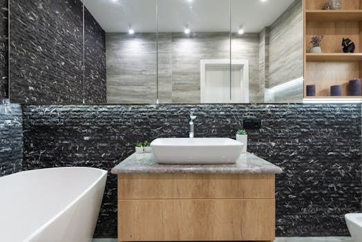 Contemporary bathroom featuring sleek decor, stone walls, and modern sink.