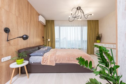 Free A stylish bedroom with wood accents, a plush bed, and modern decor. Stock Photo