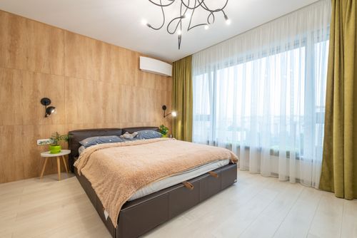 Free Comfortable bed with soft plaid placed near window with curtains in stylish bedroom in contemporary apartment Stock Photo