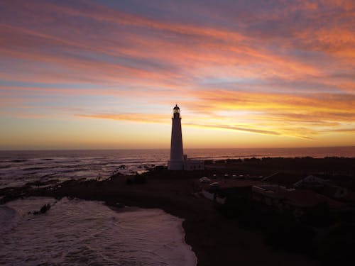Free Lighthouse Near the Sea during Sunset Stock Photo