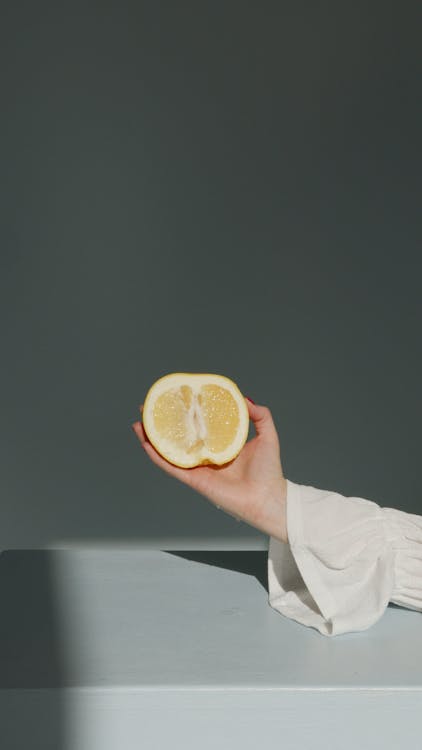 Person Holding Sliced Lemon Fruit