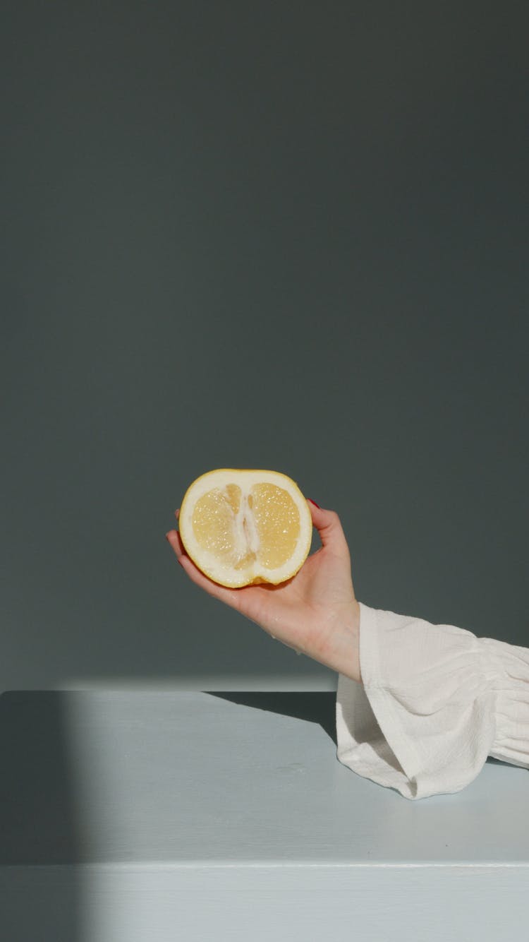 Person Holding Sliced Lemon Fruit