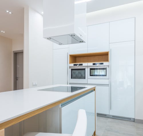 Empty kitchen with stylish white furniture