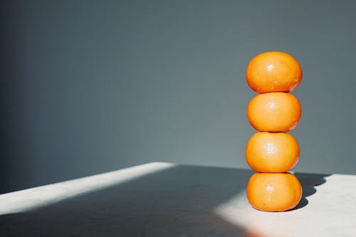 Stacked Citrus Fruits on a Table