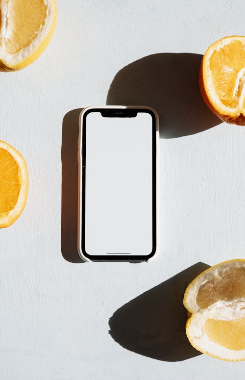 Smartphone Beside Fruit Slices