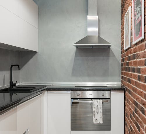 Kitchen with Gray and Brick Walls