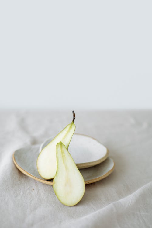 Sliced Pear Fruit Beside a Plate