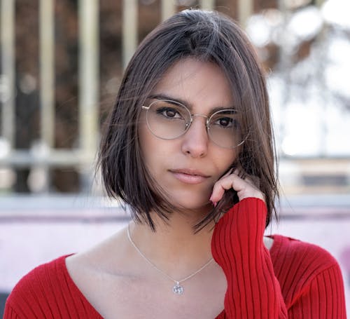 Close-Up Shot of a Pretty Woman in Red Long Sleeves