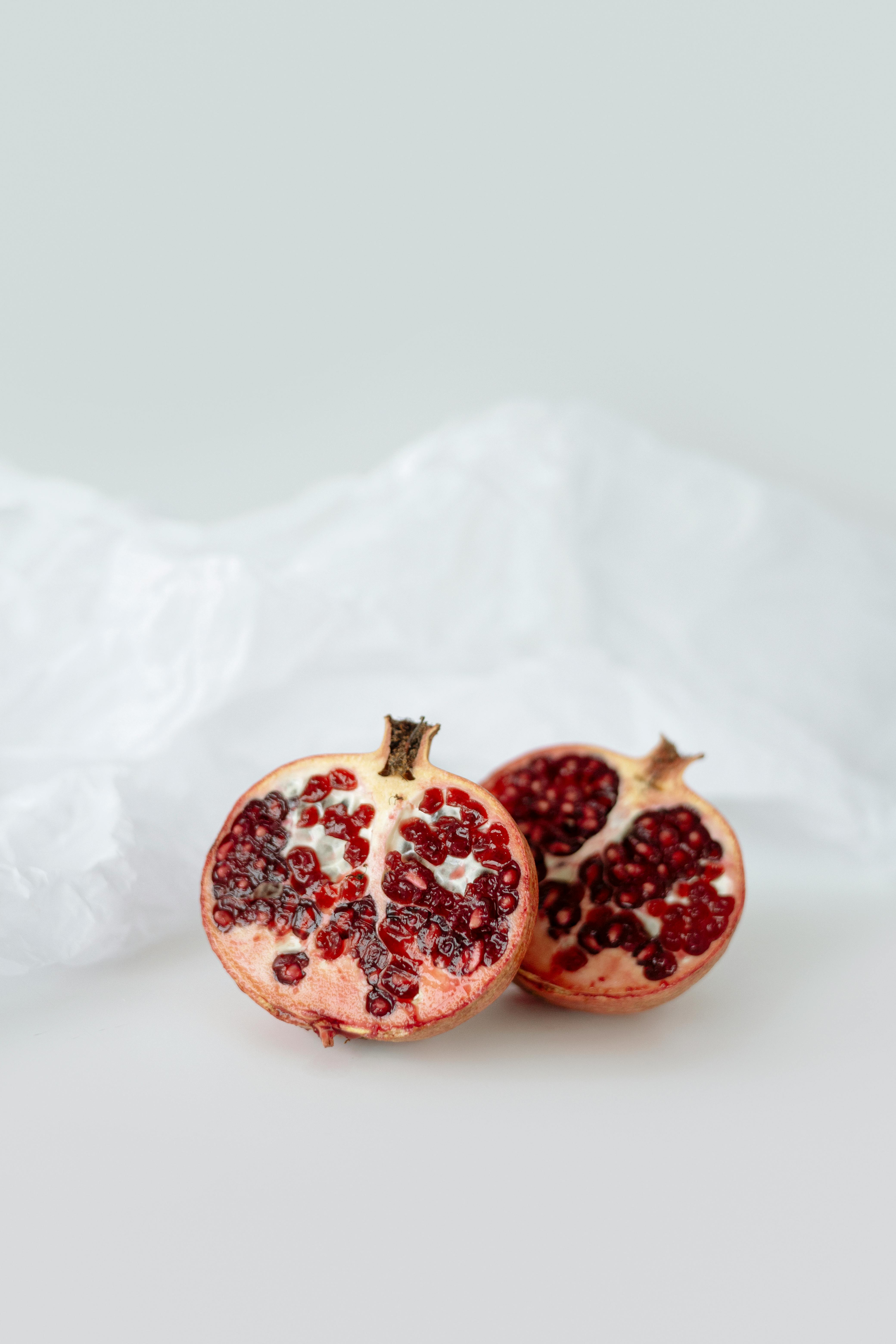 red round fruit on white textile