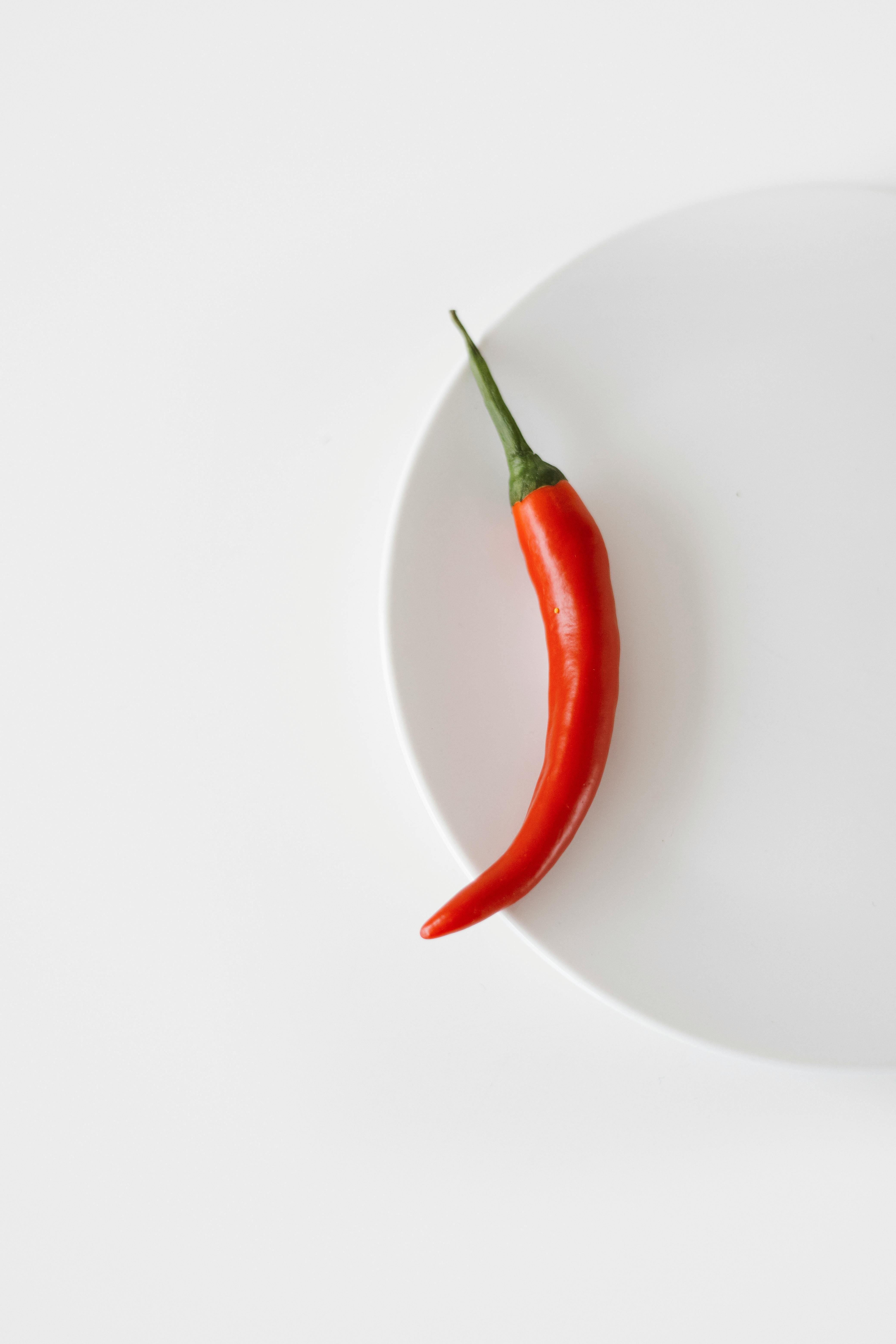 red chili on white round plate