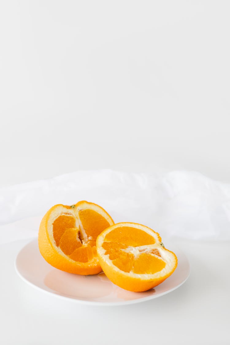 Sliced Orange Fruit On White Ceramic Plate