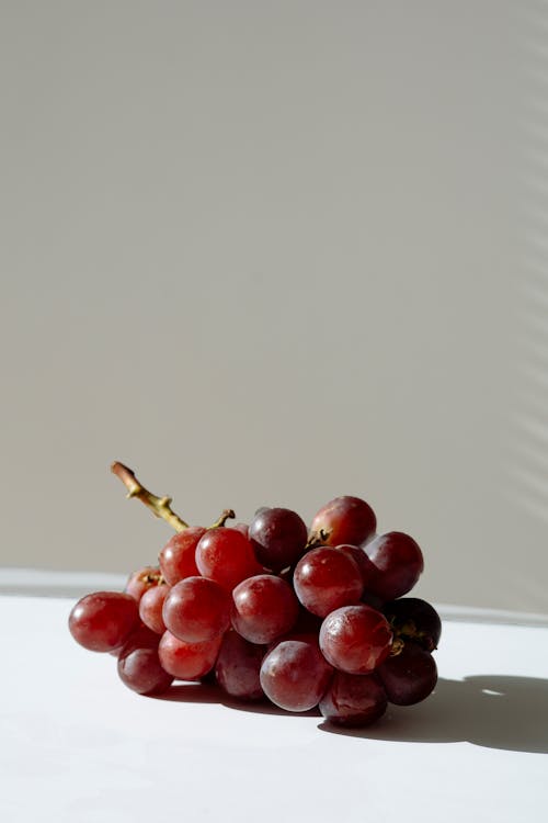 Free Grapes on White Table Stock Photo